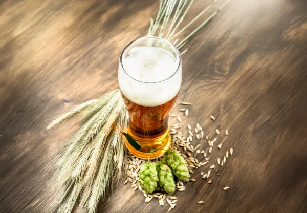 Glass of natural beer. On a wooden table.