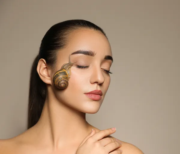 Woman with a snail on her face