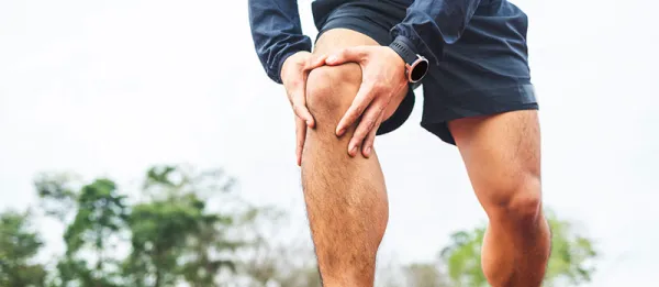 Man holding his knee